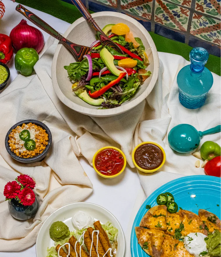 A Casa Rio patio table set with drinks and Tex-Mex plates