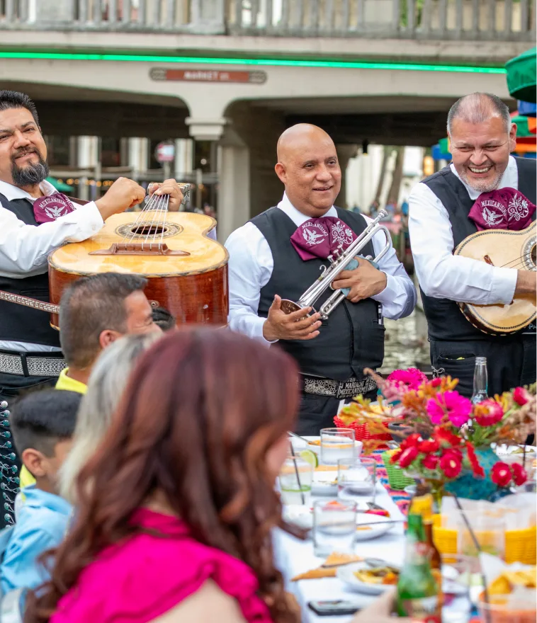A mariachi trio performing for guests at Casa Rio