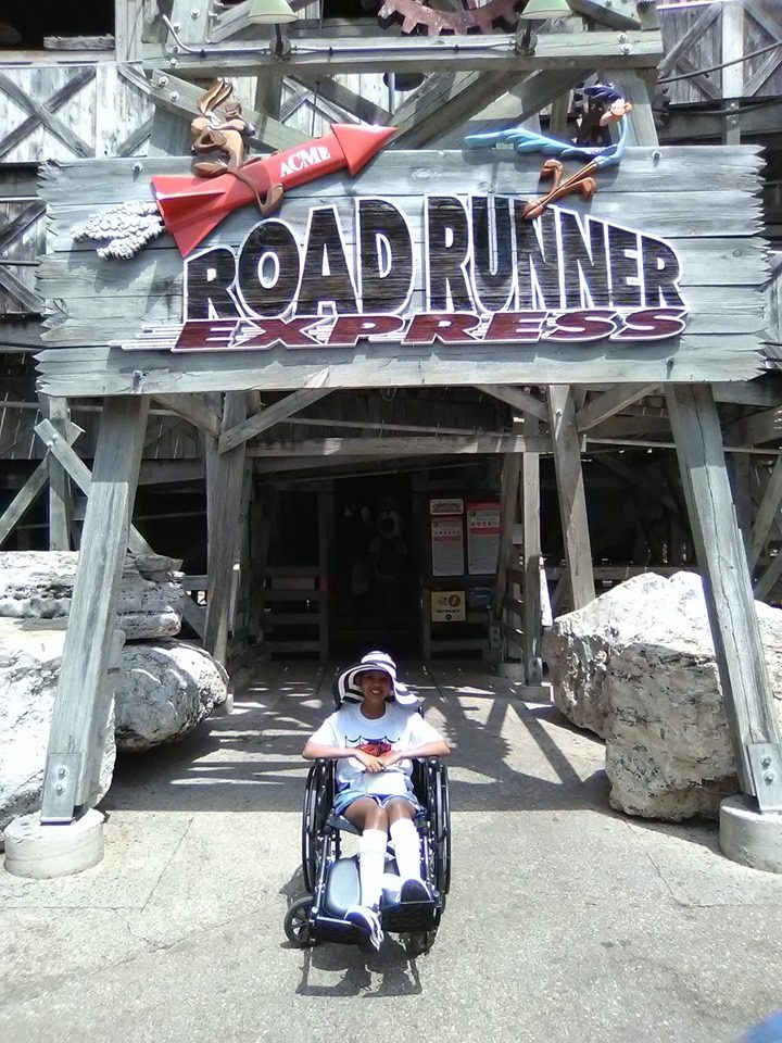 Kid in a wheelchair in front of the Road Runner Express at Six Flags Fiesta Texas